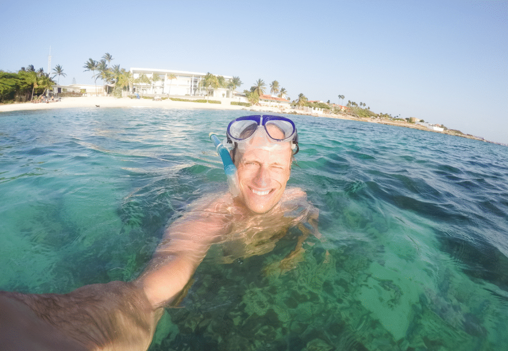Man snorkeling at Boca Catalina, one of the top Aruba snorkel sites.
