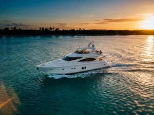 Luxury white yacht cruising through turquoise Caribbean waters at golden hour with Aruban coastline in background